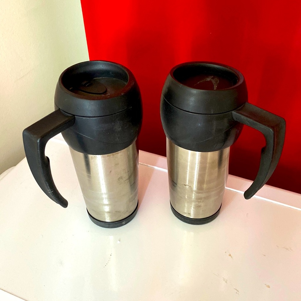 Pair of stainless steel travel coffee mugs with handles